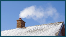 roof with snow and brown chimney with smoke