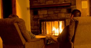 Couple sitting in front of Fireplace - Chimney Expert Milwaukee